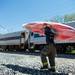 A firefighter works to clean up kayaks spilled when an Amtrak train struck a semitrailer on the tracks near Huron River Drive in Ann Arbor Township Saturday, May 25.
Courtney Sacco I AnnArbor.com